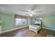 Bright bedroom with hardwood floors, a ceiling fan, and a large window providing ample natural light at 1612 Forum Ln, Iron Station, NC 28080