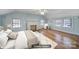 Spacious virtually staged bedroom boasts natural light, a fireplace and hardwood flooring at 1612 Forum Ln, Iron Station, NC 28080