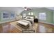 Virtually staged bedroom showcasing decorative furniture, ample windows, and neutral color palette at 1612 Forum Ln, Iron Station, NC 28080