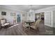 Formal dining area with hardwood floors, a chandelier, and neutral paint at 1612 Forum Ln, Iron Station, NC 28080
