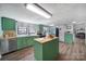 Stylish kitchen featuring an island, stainless steel appliances, and light wood cabinets at 1612 Forum Ln, Iron Station, NC 28080