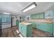 Modern kitchen with an island, stainless steel appliances, and light green cabinets at 1612 Forum Ln, Iron Station, NC 28080