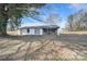 Exterior view of storage building with partial open bay situated on wooded lot at 1612 Forum Ln, Iron Station, NC 28080