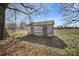 Outbuilding on lot featuring covered entryway and simple design beneath tree canopy at 1612 Forum Ln, Iron Station, NC 28080
