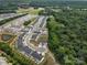 An aerial view of homes in a suburban community next to a lush green forest at 212 Briana Marie Way, Indian Trail, NC 28079