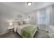 Comfortable bedroom with neutral tones, soft bedding, and natural light from the window at 212 Briana Marie Way, Indian Trail, NC 28079