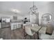 Elegant dining area open to the kitchen, featuring modern lighting and neutral tones at 212 Briana Marie Way, Indian Trail, NC 28079