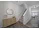 Welcoming entryway featuring a staircase, wood-look flooring, and stylish decor at 212 Briana Marie Way, Indian Trail, NC 28079