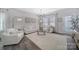 Bright living room with neutral decor, featuring a large area rug and ample natural light at 212 Briana Marie Way, Indian Trail, NC 28079