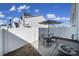 Private patio with a dining set, an umbrella, and a fenced yard at 212 Briana Marie Way, Indian Trail, NC 28079