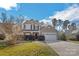 Charming two-story home featuring manicured landscaping and a two-car garage, set against a backdrop of mature trees and blue sky at 2130 Clear Brooke Dr, Kannapolis, NC 28083