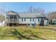 View of the home's backyard with a screened porch and colorful chairs on the lawn at 285 Fryling Sw Ave, Concord, NC 28025