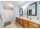 Bright bathroom with dual sinks, wood cabinetry, and walk-in shower at 285 Fryling Sw Ave, Concord, NC 28025