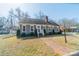 Charming exterior view of home with manicured lawn, bushes, and brick walkway at 285 Fryling Sw Ave, Concord, NC 28025