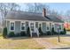 Charming exterior view of home with manicured lawn, bushes, and brick walkway at 285 Fryling Sw Ave, Concord, NC 28025