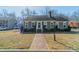 Charming exterior view of home with manicured lawn, bushes, and brick walkway at 285 Fryling Sw Ave, Concord, NC 28025