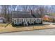 Charming exterior view of home with manicured lawn, bushes, and brick walkway at 285 Fryling Sw Ave, Concord, NC 28025