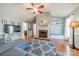 Open living room featuring a ceiling fan, fireplace, and hardwood floors at 285 Fryling Sw Ave, Concord, NC 28025