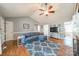 Inviting living room features hardwood floors, vaulted ceiling with fan, and wainscoting detail at 285 Fryling Sw Ave, Concord, NC 28025