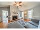 Cozy living room with a fireplace, hardwood floors, and a comfortable gray sofa at 285 Fryling Sw Ave, Concord, NC 28025