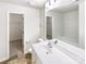 Bright bathroom showcasing a large mirror, white vanity, and a separate room with a tub at 3113 Ellingford Rd, Charlotte, NC 28214