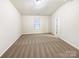 A carpeted bedroom offering natural light through a window at 3113 Ellingford Rd, Charlotte, NC 28214