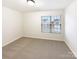 A carpeted bedroom offering natural light through a window at 3113 Ellingford Rd, Charlotte, NC 28214