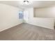 A carpeted bedroom with a window and a closet at 3113 Ellingford Rd, Charlotte, NC 28214