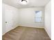 A carpeted bedroom with a window and a closet at 3113 Ellingford Rd, Charlotte, NC 28214
