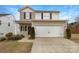 Charming two-story home featuring a two-car garage and neutral siding and inviting curb appeal at 3113 Ellingford Rd, Charlotte, NC 28214