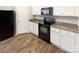 Kitchen featuring white cabinets, granite countertops and black appliances at 3113 Ellingford Rd, Charlotte, NC 28214