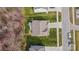 A high aerial view of a home with a brown roof, green lawn, and concrete driveway at 3114 Woodlands Creek Dr, Monroe, NC 28110