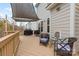Comfortable back deck with seating area, string lights, and shade cover at 3114 Woodlands Creek Dr, Monroe, NC 28110