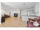 Open basement area featuring hard wood floors, grey kitchen and a leather couch at 3114 Woodlands Creek Dr, Monroe, NC 28110
