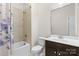 Cozy bathroom with shower-tub combination, neutral tile, and modern vanity at 3114 Woodlands Creek Dr, Monroe, NC 28110