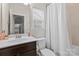 A bathroom featuring a shower-tub combination with a dark vanity and natural lighting at 3114 Woodlands Creek Dr, Monroe, NC 28110