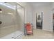 Modern bathroom with a glass-enclosed shower and neutral tile at 3114 Woodlands Creek Dr, Monroe, NC 28110