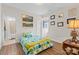 Cozy bedroom features hardwood floors and cheerful, patterned bedding with easy access to the adjoining bathroom at 3114 Woodlands Creek Dr, Monroe, NC 28110