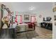 A bedroom featuring a large bed, wood floors, multiple decor items, and bright windows with red curtains at 3114 Woodlands Creek Dr, Monroe, NC 28110