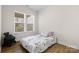 Bright bedroom with light wood floors, natural light, and comfortable bed at 3114 Woodlands Creek Dr, Monroe, NC 28110