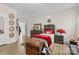 A bedroom featuring hardwood floors, large bed, decor items and adjacent walk-in closet at 3114 Woodlands Creek Dr, Monroe, NC 28110