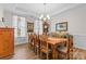 Formal dining room features a large wooden table and elegant chandelier at 3114 Woodlands Creek Dr, Monroe, NC 28110