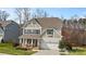 Charming two-story home features a covered front porch and a two-car garage at 3114 Woodlands Creek Dr, Monroe, NC 28110