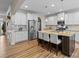 Spacious kitchen with white cabinets, granite countertops, and a large island at 3114 Woodlands Creek Dr, Monroe, NC 28110