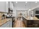 Gourmet kitchen boasts granite counters, stainless steel appliances, and a central island at 3114 Woodlands Creek Dr, Monroe, NC 28110