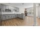 Modern kitchen featuring gray cabinets, stainless steel appliances, and hardwood floors with a casual dining area at 3114 Woodlands Creek Dr, Monroe, NC 28110
