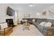 Bright living room with fireplace, large TV, wood floors and large sofa at 3114 Woodlands Creek Dr, Monroe, NC 28110