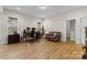 Spacious living room features wood floors, natural light, and comfortable seating at 3114 Woodlands Creek Dr, Monroe, NC 28110