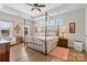 Main bedroom with a four poster bed, wood floors, and lots of natural light at 3114 Woodlands Creek Dr, Monroe, NC 28110