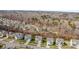 A lovely aerial view of a neighborhood lined with houses and large yards near the woods at 3114 Woodlands Creek Dr, Monroe, NC 28110